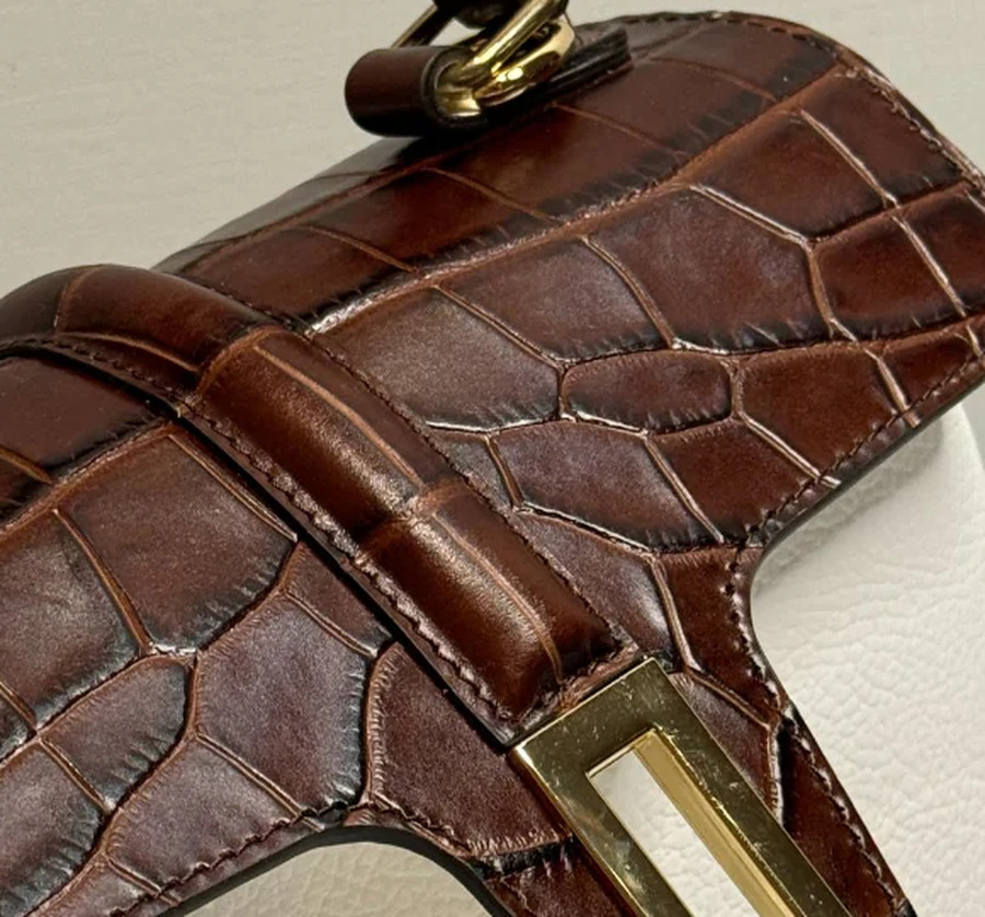The turnlock and the crocodile embossed flap