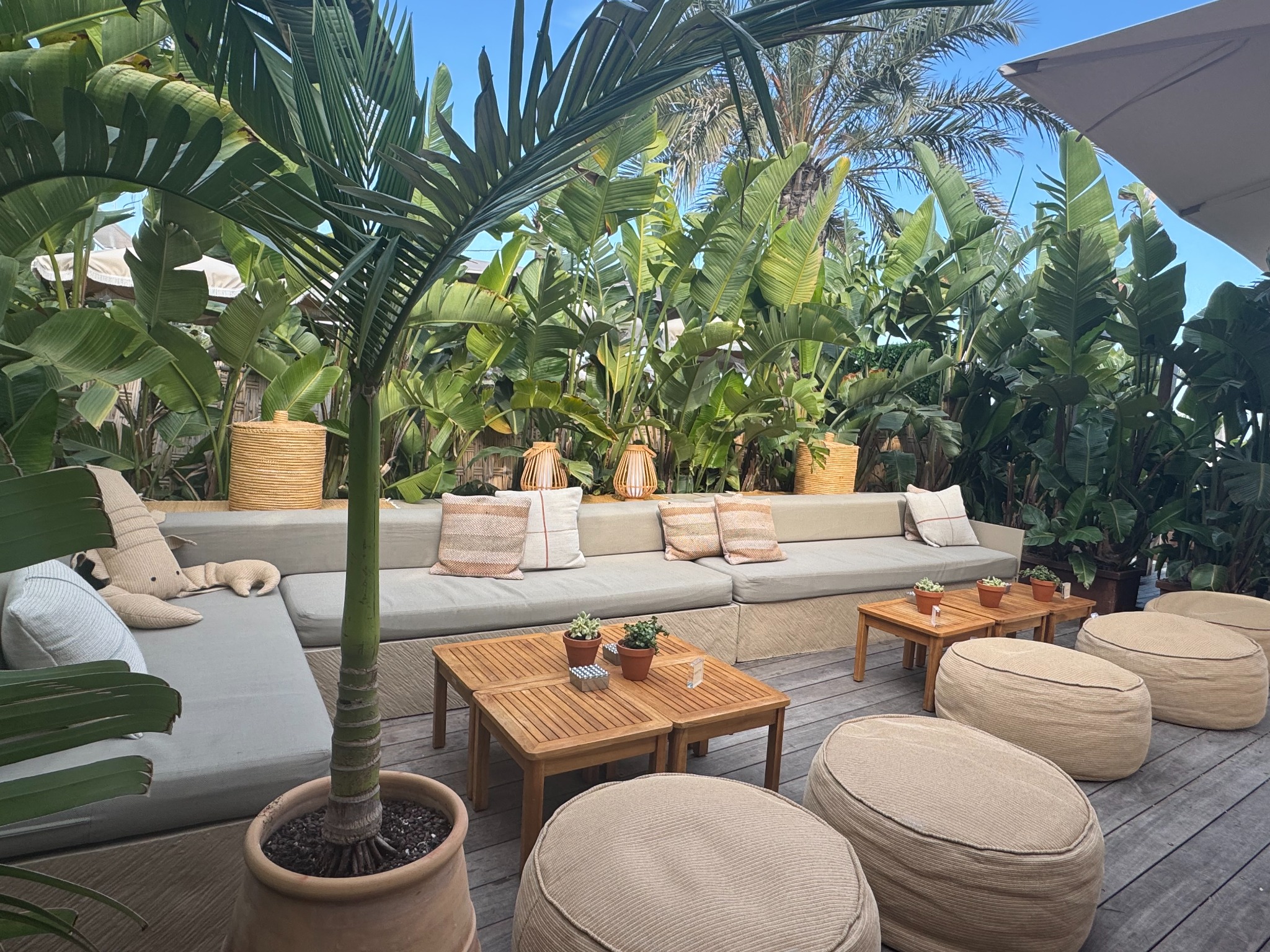 La Note Bleue Monaco beach club terrace surrounded by tropical greenery